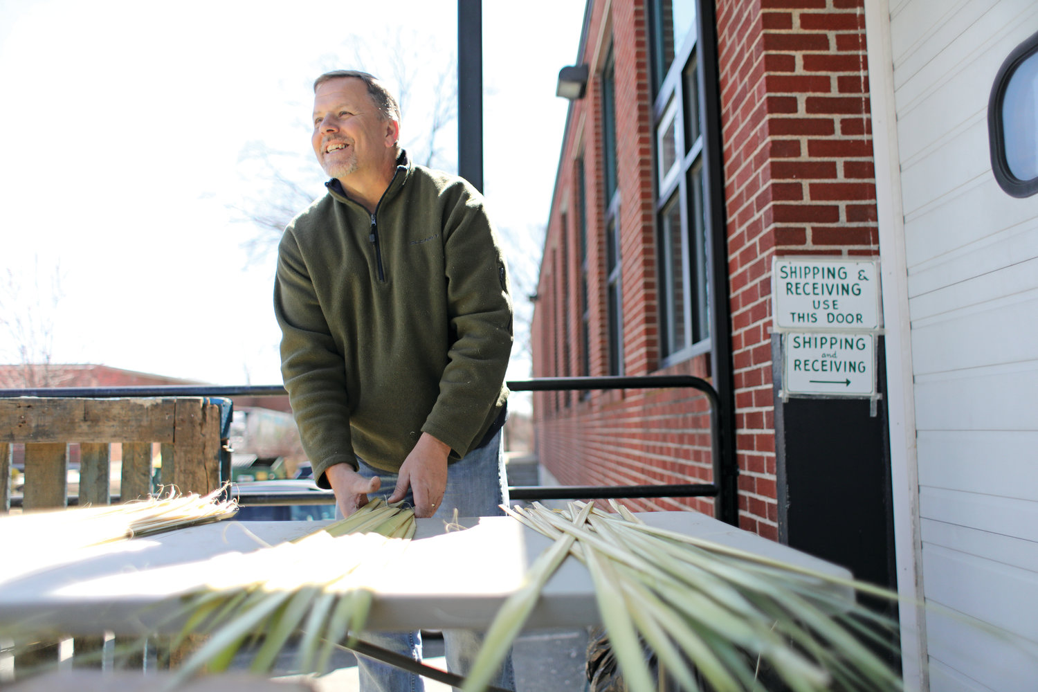 Tom Tally works hard preparing palms as Holy Week quickly approaches
in the Diocese of Providence.